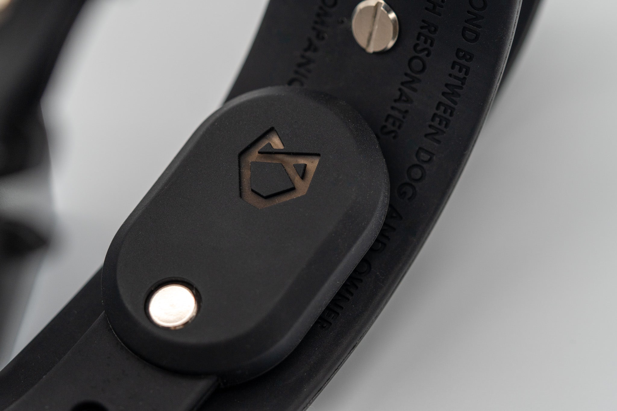 Detailed view of the black Little Lupo AirTag Holder on a Little Lupo dog collar, emphasizing the precise fit and the premium LFGB silicone material. It also has embossed on it the Little Lupo logo mark.